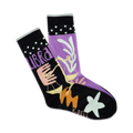 A pair of crew socks in purple and black, featuring the Libra zodiac symbol, pastel design elements, and white polka dots on the cuff.