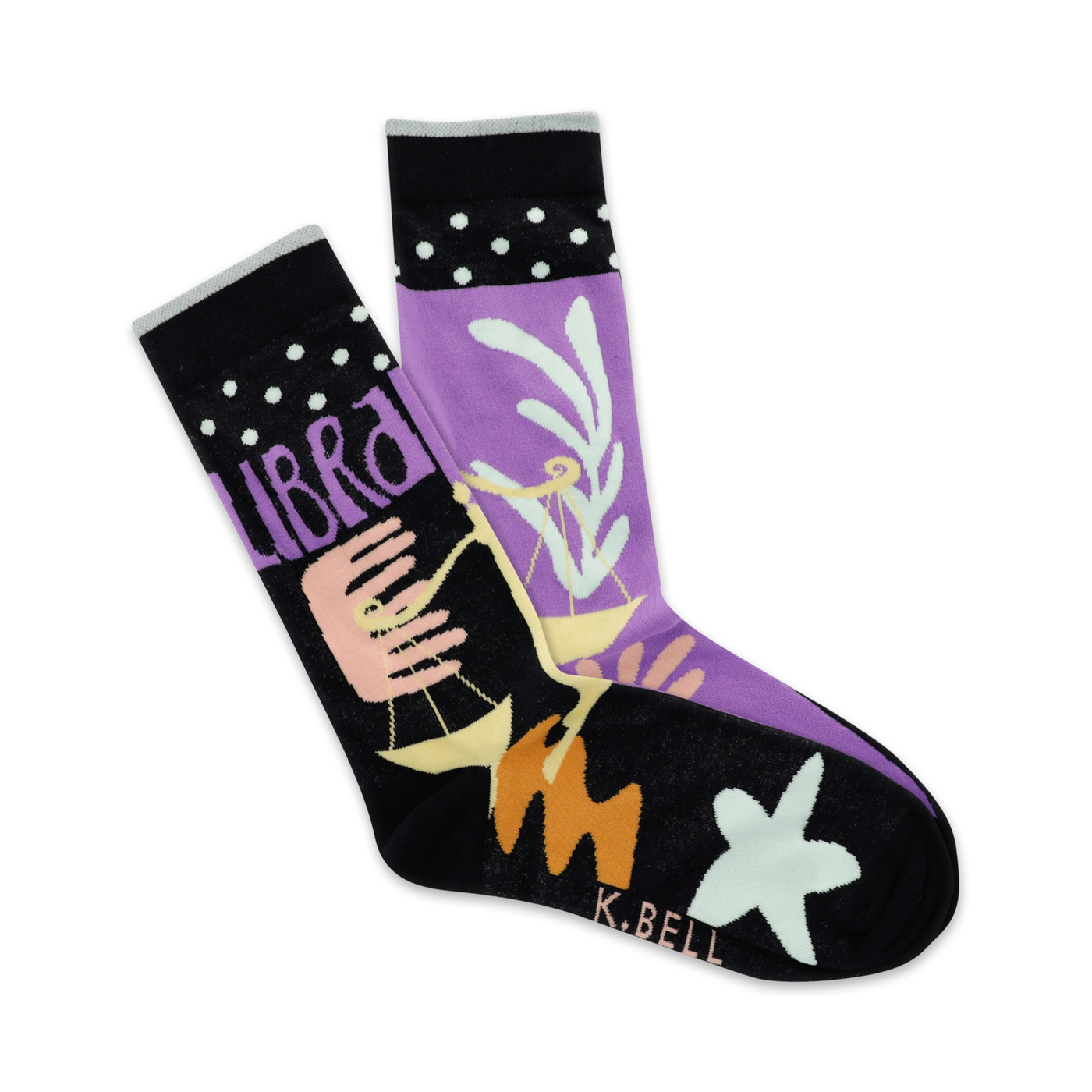 A pair of crew socks in purple and black, featuring the Libra zodiac symbol, pastel design elements, and white polka dots on the cuff.