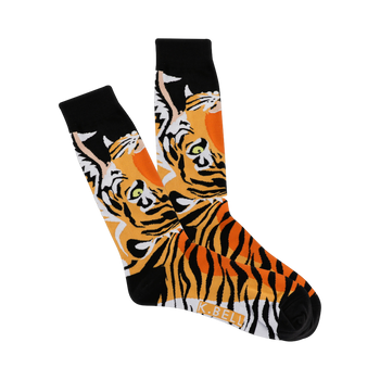A pair of crew socks with a tiger face design. The tigers are predominantly orange and black with green eyes, set against a black background.