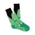 Pair of crew socks with a green lizard design. The lizards have open mouths, yellow eyes, and are shown on a black background.