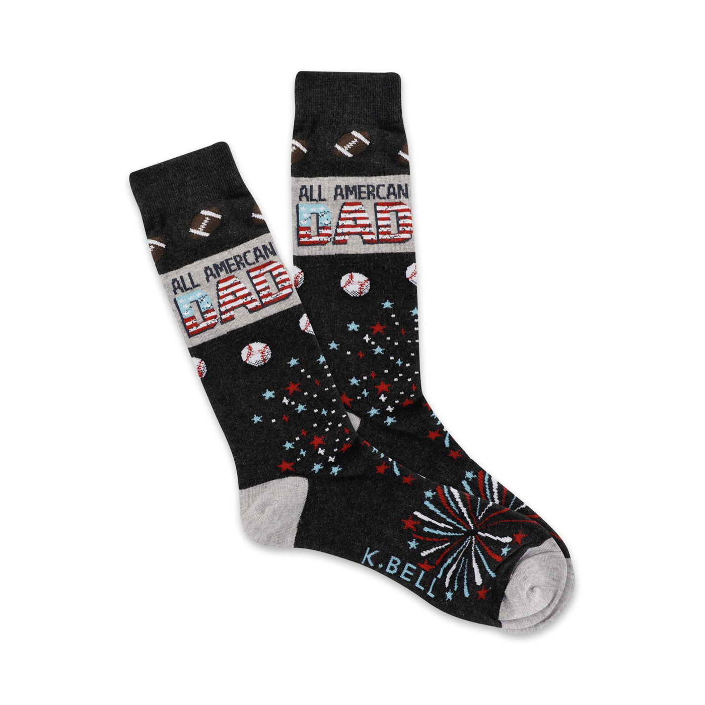 Pair of dark gray crew socks with an 'All American Dad' design. Features red, white, and blue stars, baseballs, footballs, and fireworks.