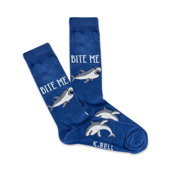 A pair of blue crew socks with grey sharks and the text 'Bite Me' printed on them. 