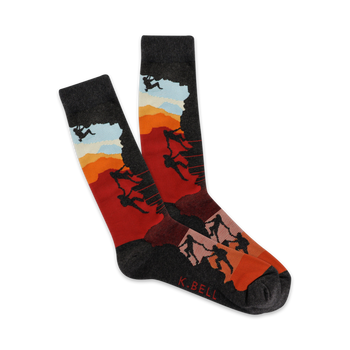 mens black, red, orange, and light blue sunset climbers crew socks feature mountain climbers on a mountain.  