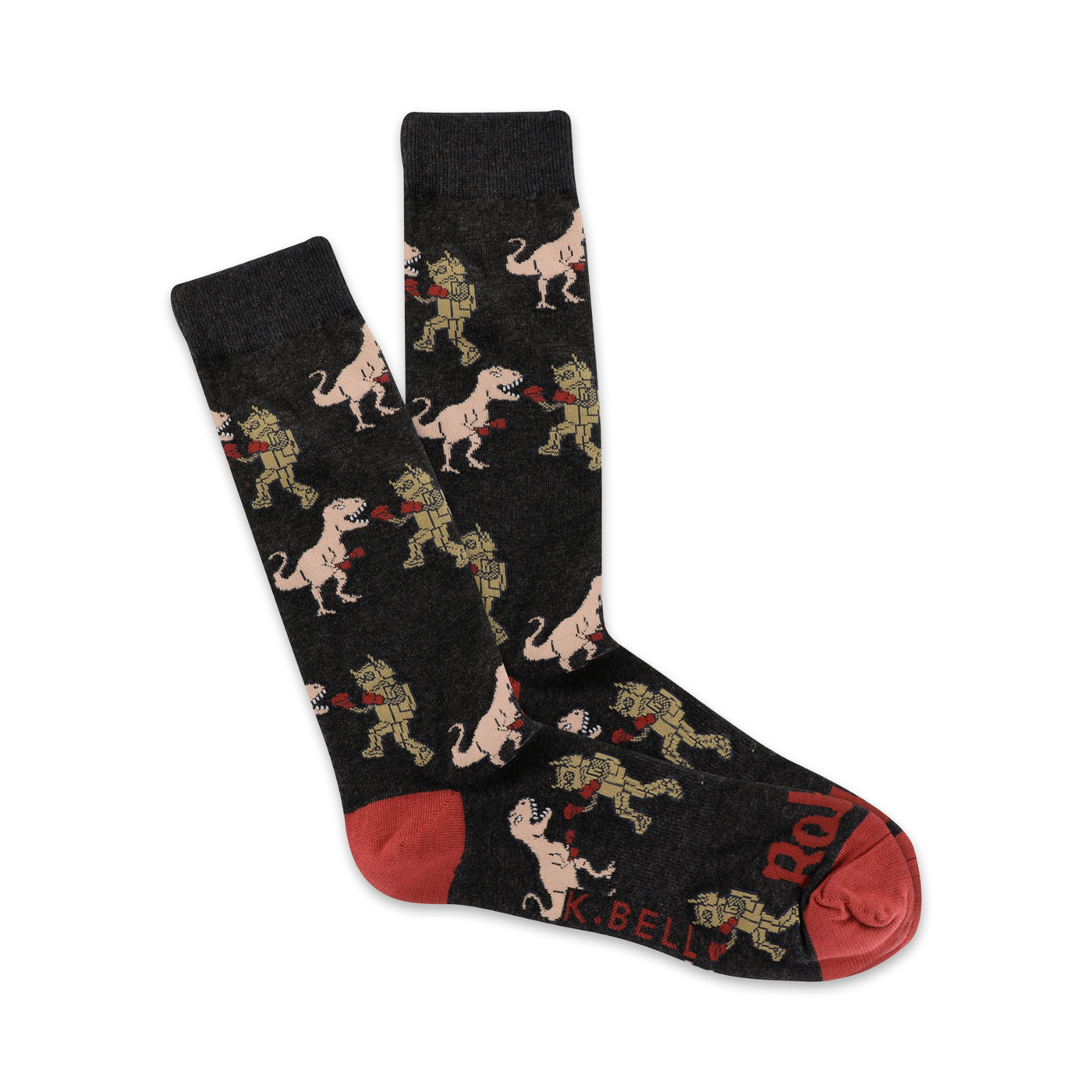 Pair of dark grey crew socks with a repeating pattern of cartoon T-Rexes boxing robots. Red accents on the heel and toe.