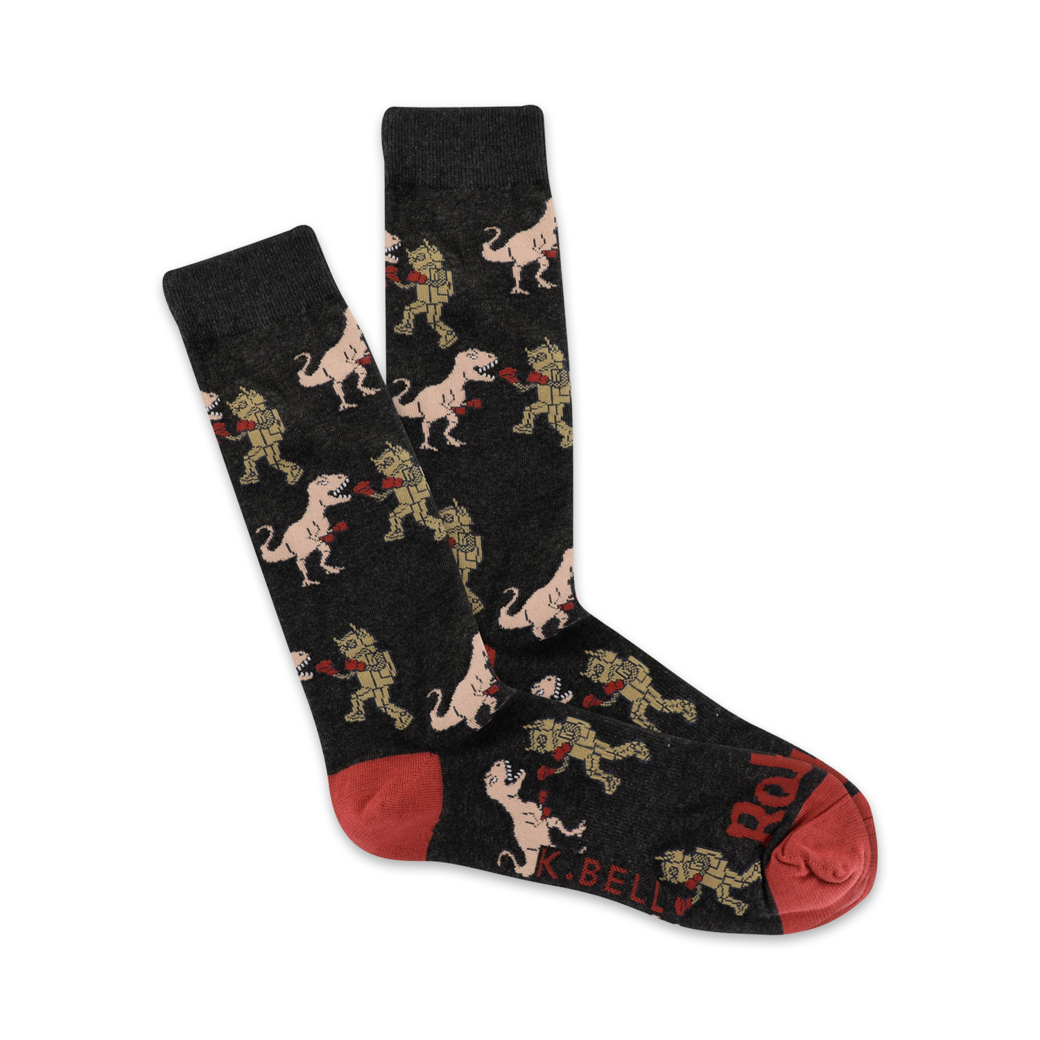 Pair of dark grey crew socks with a repeating pattern of cartoon T-Rexes boxing robots. Red accents on the heel and toe.