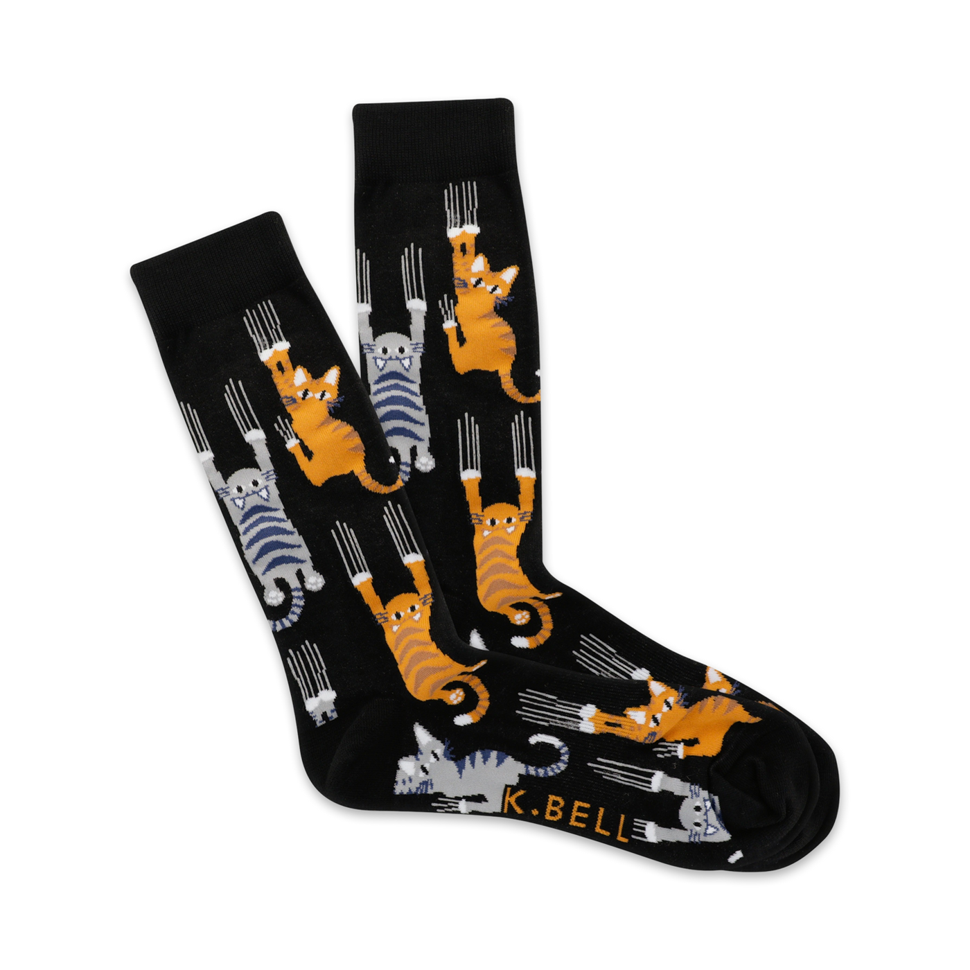 Pair of black crew socks with orange and gray cats clinging playfully. The cats have sharp claws and are set against a dark background.