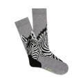 Pair of grey crew socks with a black and white zebra print.  The zebras' faces are prominently featured at the bottom of the socks.