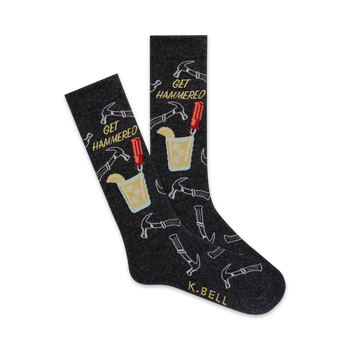 black crew socks with hammers, screwdrivers and a mixed drink with lemon wedge. the words 'get hammered' are knit into the sock  