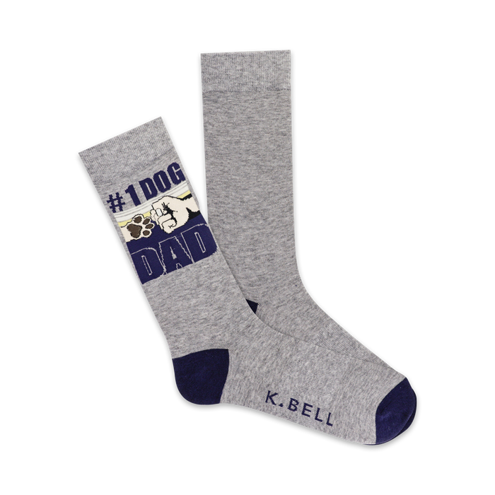 crew-length gray socks with '{#1 dog dad}' on the left sock and a paw print on the right sock.   }}