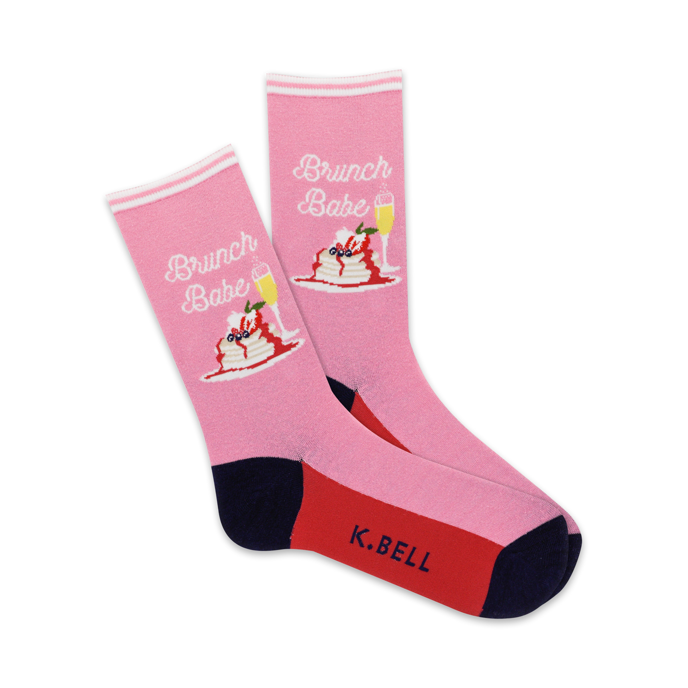 A pair of pink crew socks with a graphic of pancakes, berries, and champagne.  The socks have navy and red accents and say 'Brunch Babe'.