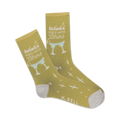 Pair of crew socks in mustard yellow. Design features white text 'Drinks Well With Others' and light green margarita glasses. Small white crosses are scattered on the socks.