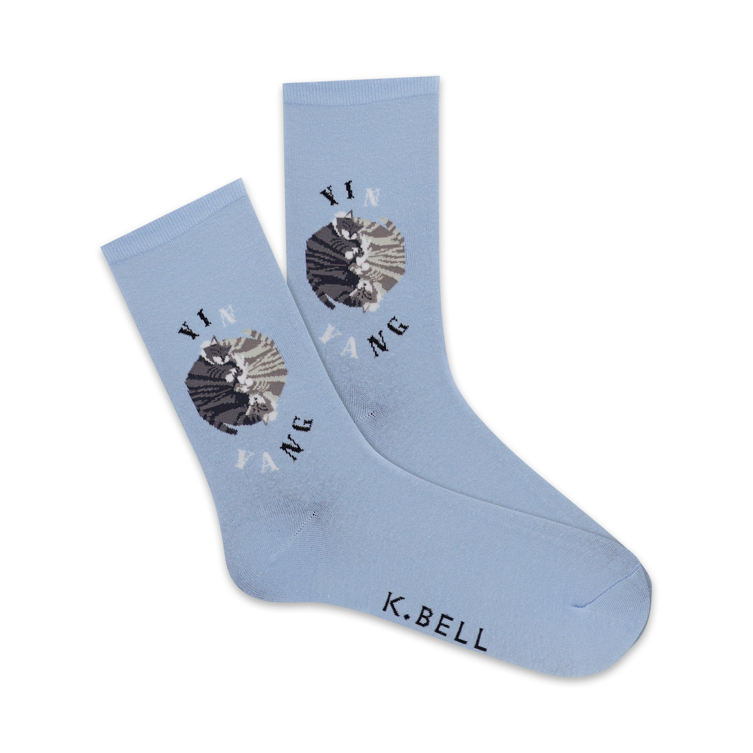 Pair of light blue crew socks with a yin yang design featuring two cats in gray and white.  'Yin Yang' and 'K.Bell' are printed on the socks.