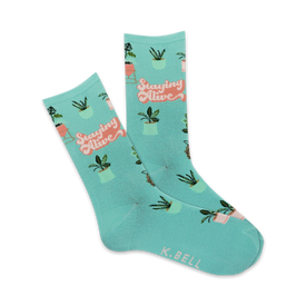 mint green crew socks with pink potted houseplants and the words "staying alive" in coral.  