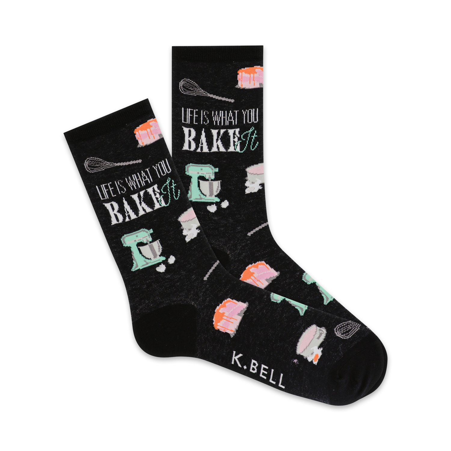 A pair of black crew socks with a baking-themed design. The socks feature pastel-colored images of cakes, whisks, and stand mixers, along with the text 'Life is what you bake it'.