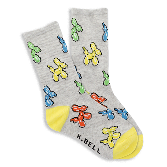 Pair of gray crew socks with colorful balloon dog pattern in yellow, blue, green, red. Bright yellow heel and toe sections visible. }}