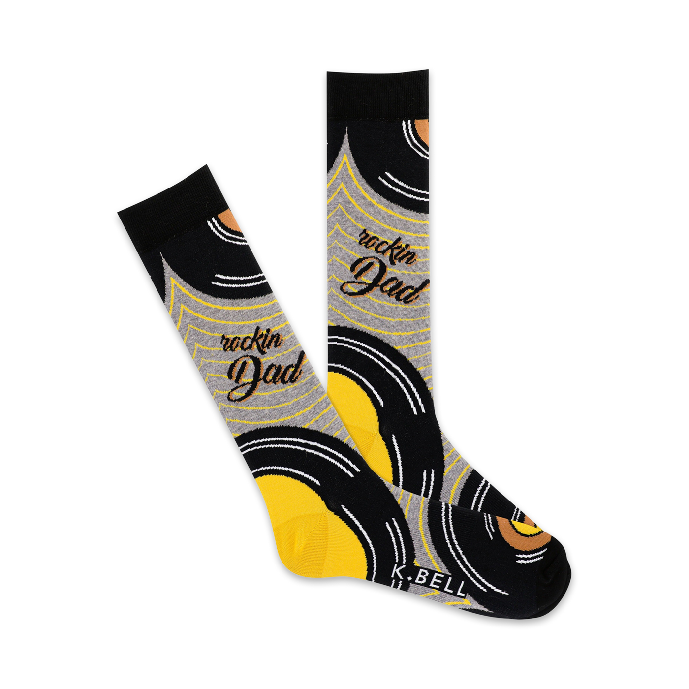 A pair of crew socks with a vinyl record design in black, yellow, and grey.  The words 'Rockin' Dad' are written on the socks.