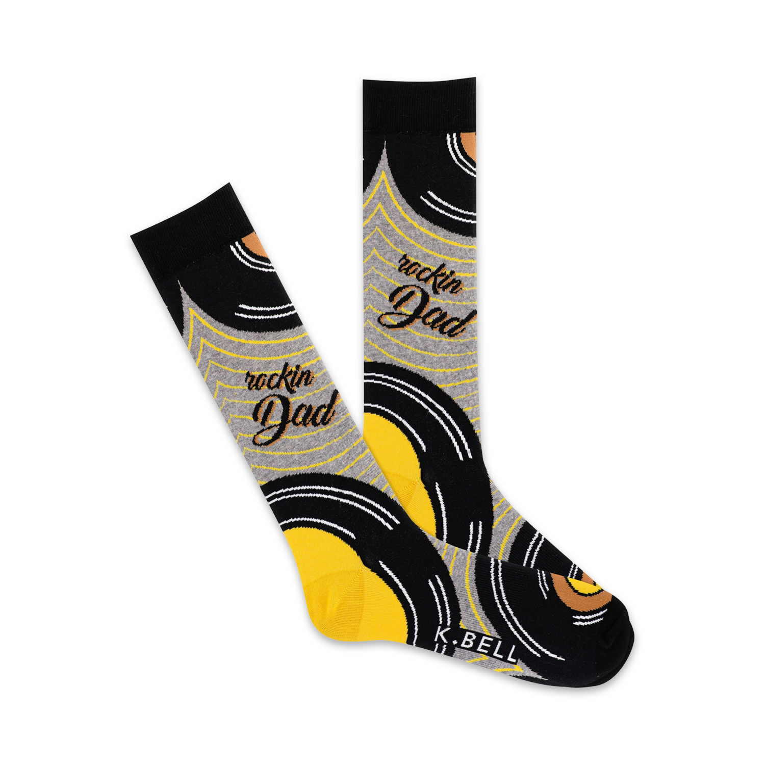 A pair of crew socks with a vinyl record design in black, yellow, and grey.  The words 'Rockin' Dad' are written on the socks.
