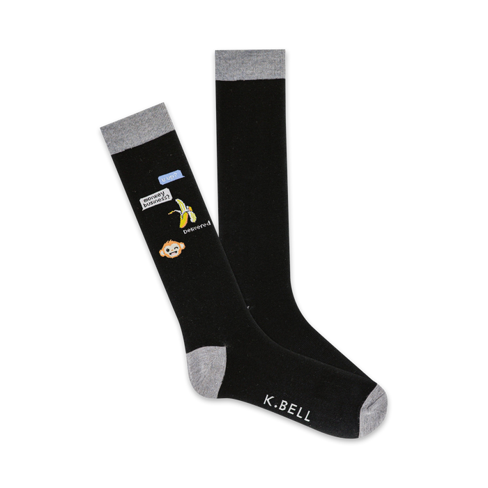 black crew socks with gray toes, heels, and cuffs featuring a sassy monkey holding a banana and a cell phone with text bubble saying 