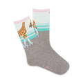 Grey crew socks with a whimsical design. A giraffe in roller skates is featured against a teal and white background. Pink accents add a touch of sweetness.
