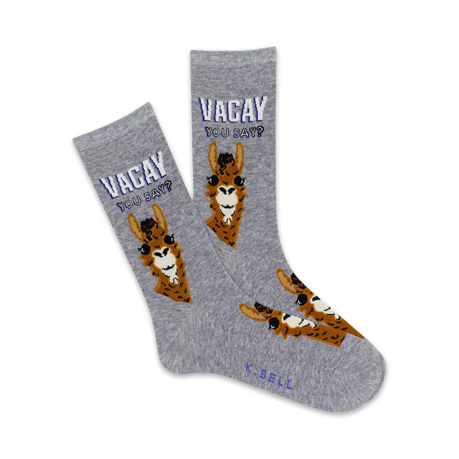 Pair of grey crew socks with brown llama illustrations and the text 'Vacay You Say?' in purple. Fun and quirky design.