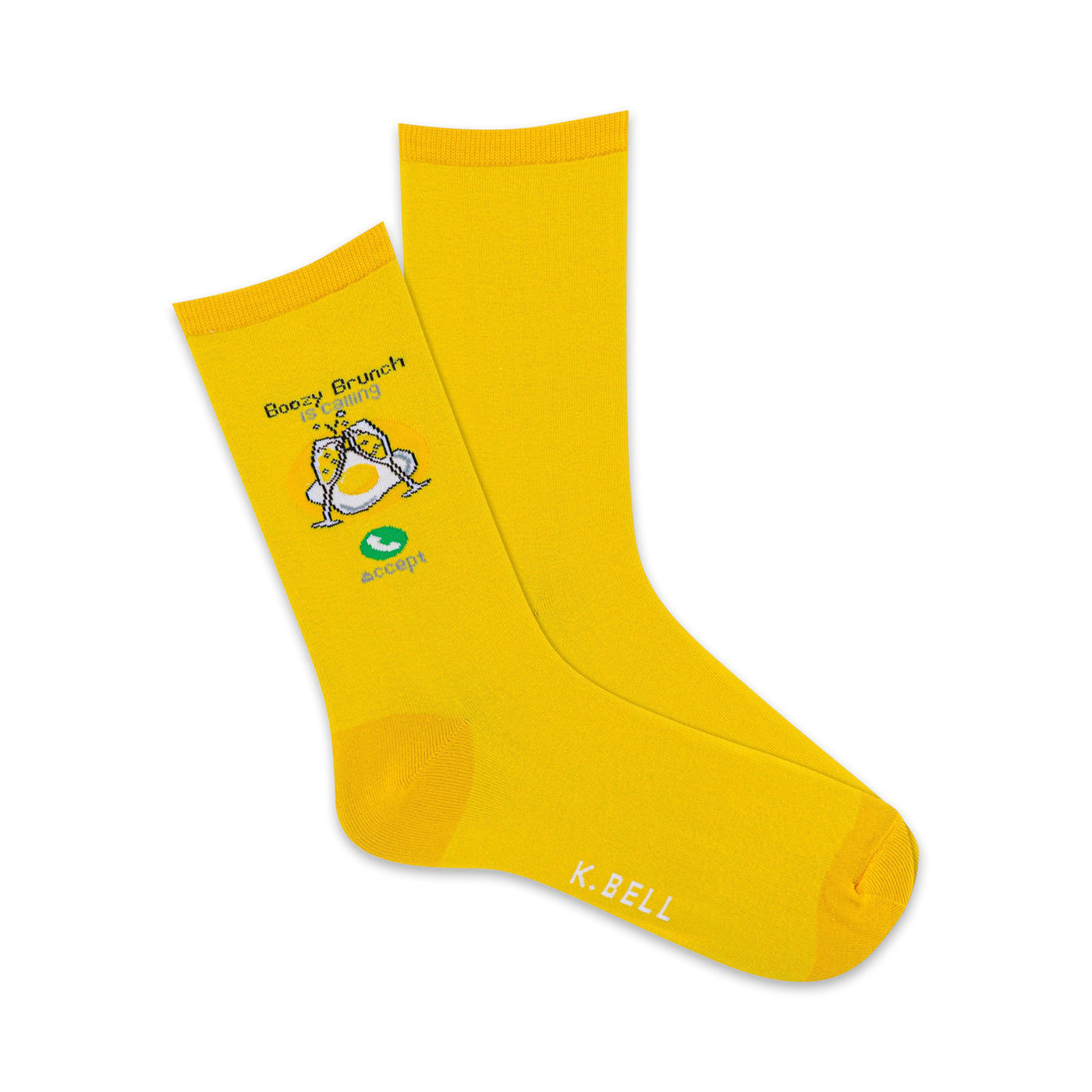 A pair of yellow crew socks with a whimsical illustration of eggs with champagne glasses, saying 'Boozy Brunch is Calling' and 'Accept'.