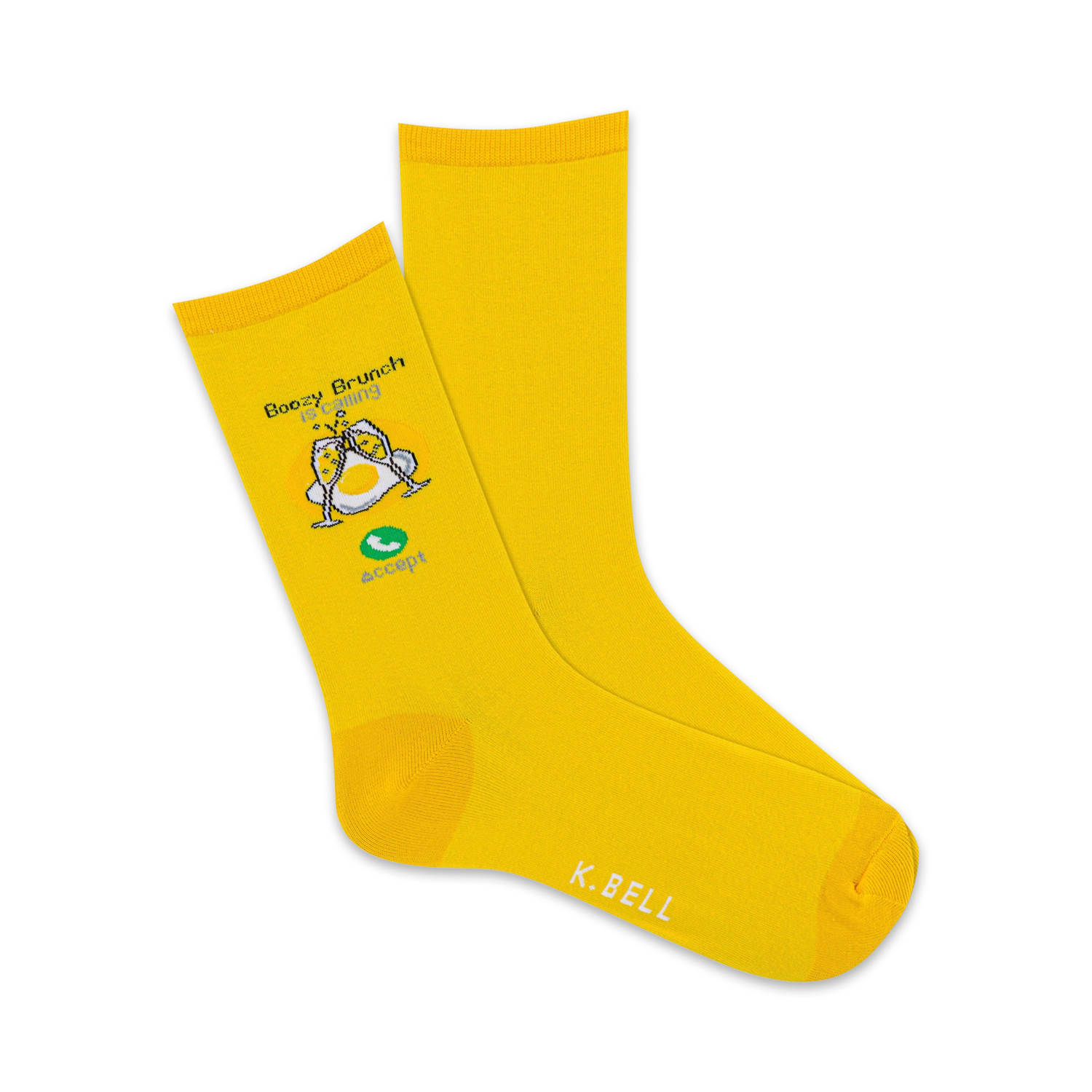 A pair of yellow crew socks with a whimsical illustration of eggs with champagne glasses, saying 'Boozy Brunch is Calling' and 'Accept'.