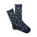 Close-up view of navy blue crew socks with a tiny white floral pattern. Pink trim at the top and 'K.BELL' logo.