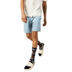 Model wearing the Tropical Floral socks with white slides and light blue shorts. [lf]