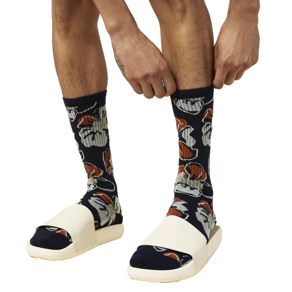 Close-up of a person putting on the Tropical Floral socks, showcasing the detail of the print. [lf]