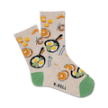 Cream-colored crew socks with illustrations of fried eggs, pancakes, coffee cups, and croissants. Green accents at the heel and toe.