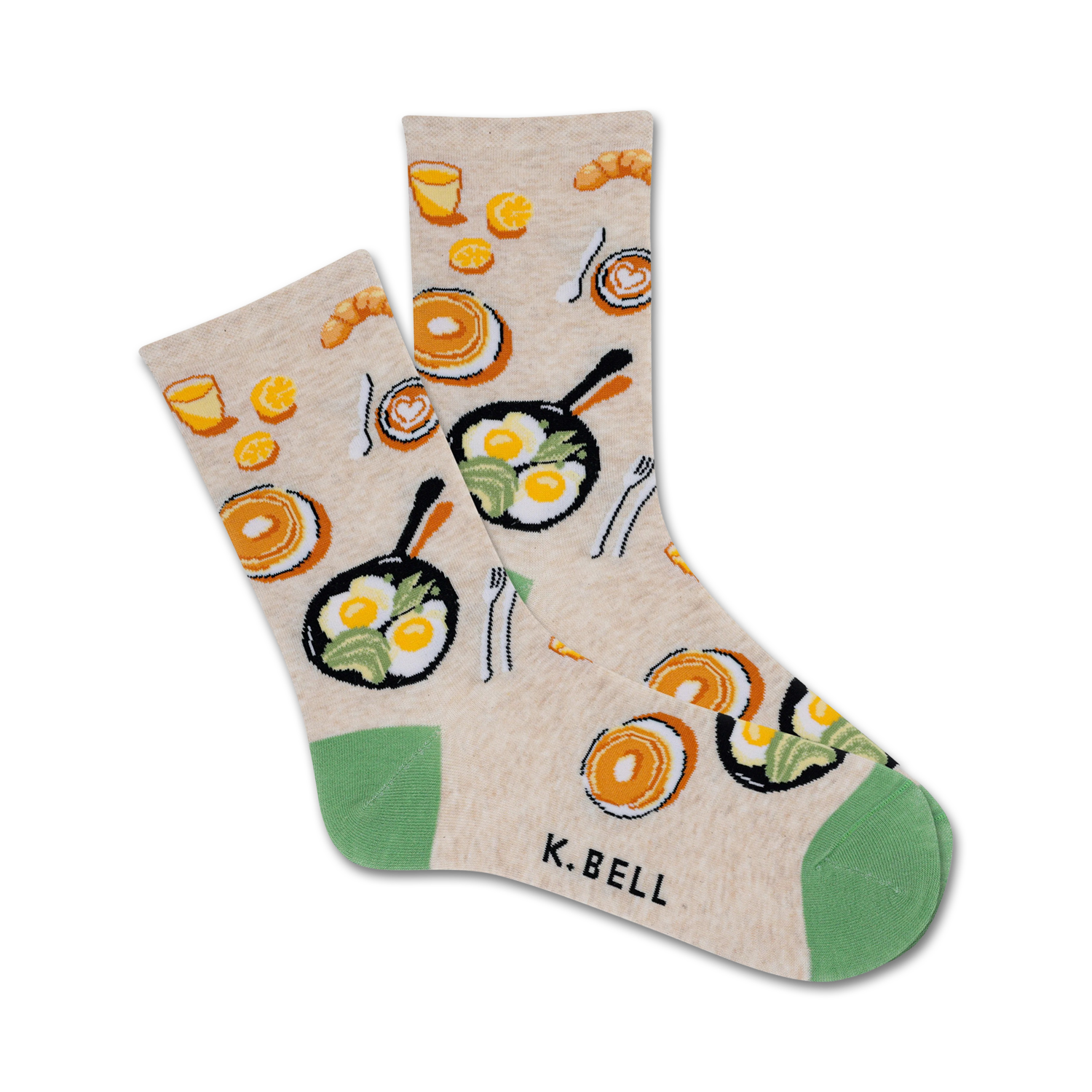 Cream-colored crew socks with illustrations of fried eggs, pancakes, coffee cups, and croissants. Green accents at the heel and toe.