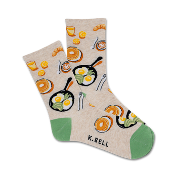 white crew socks made for women. design includes breakfast foods such as bacon, eggs, toast and coffee. toe and heel are green.  