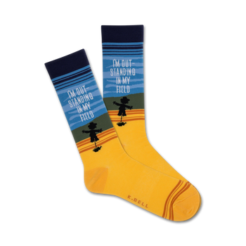   yellow crew socks with blue cuffs, brown toes, and a black scarecrow pattern. text on socks reads 'i'm outstanding in my field'.   
