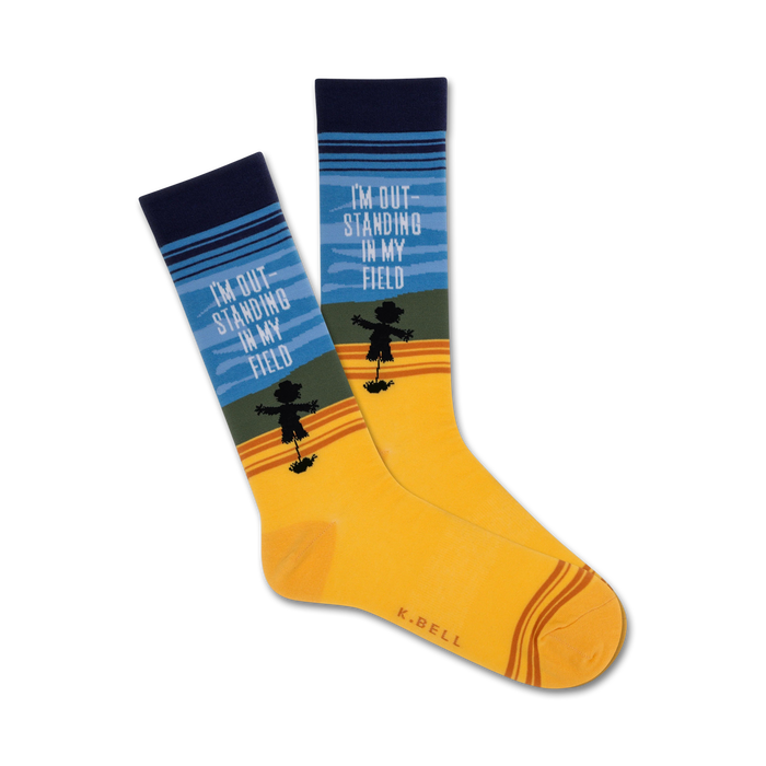   yellow crew socks with blue cuffs, brown toes, and a black scarecrow pattern. text on socks reads 'i'm outstanding in my field'.    }}