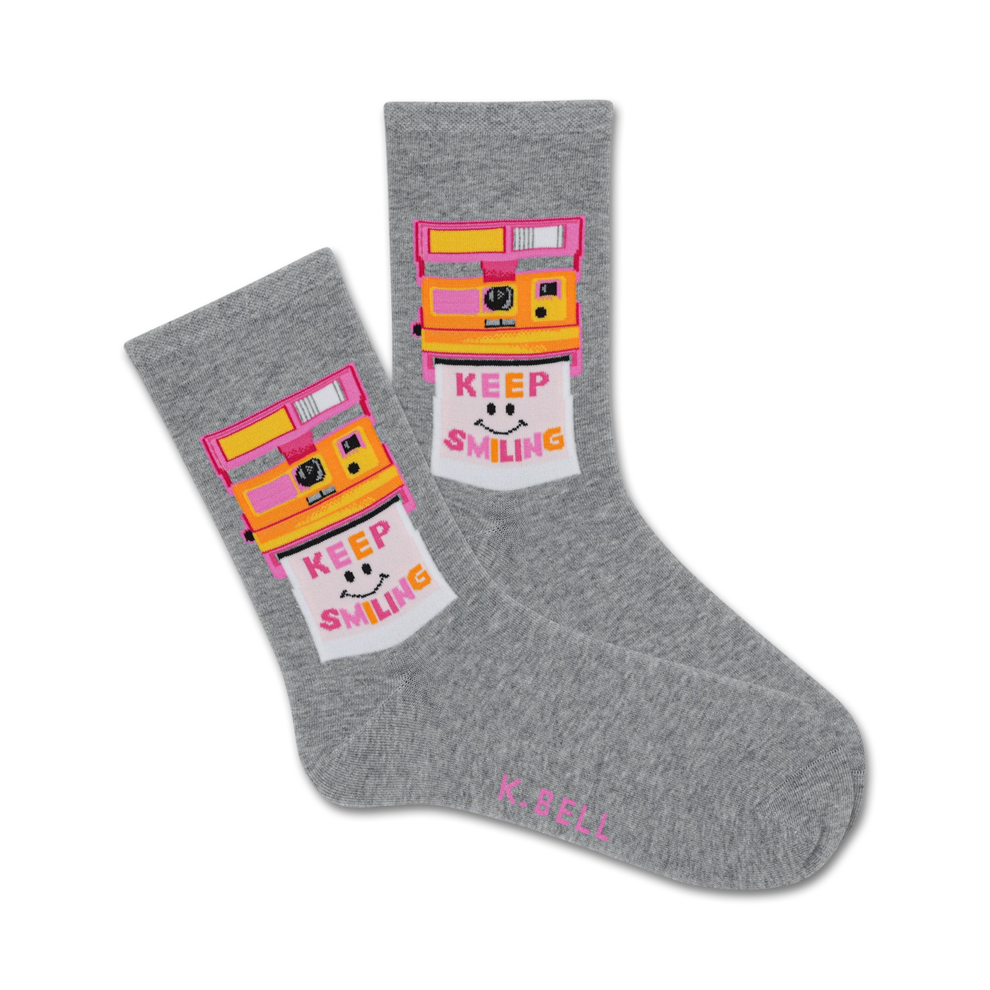 Pair of grey crew socks with a retro Polaroid camera design. The camera is yellow and pink, and the photo shows a smiling face with 'Keep Smiling' text.
