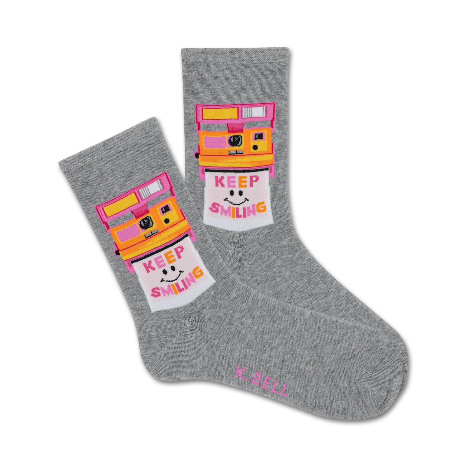 Pair of grey crew socks with a retro Polaroid camera design. The camera is yellow and pink, and the photo shows a smiling face with 'Keep Smiling' text.