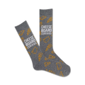 Pair of gray crew socks with an all-over print of yellow cheese wedges and the text 'Cheese Board Certified.'