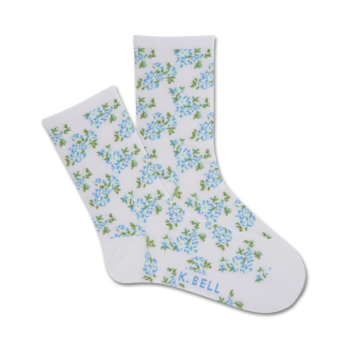 crew length women's socks in white with pattern of small blue flowers and green leaves. perfect for cottage core aesthetic.    }}