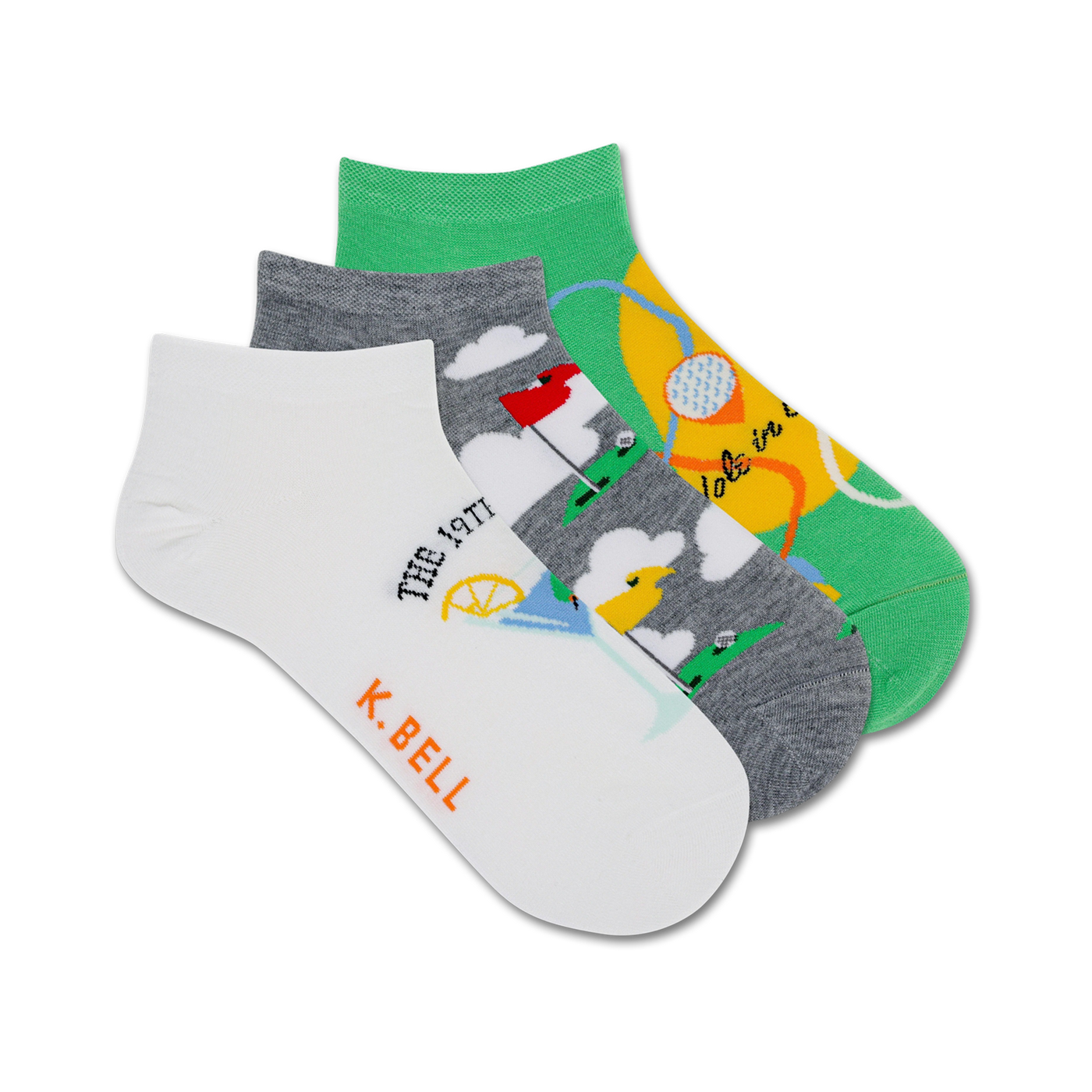 Three ankle socks; one white with golf-themed illustration, one gray with golf course, one green with golf ball. K. Bell logo.