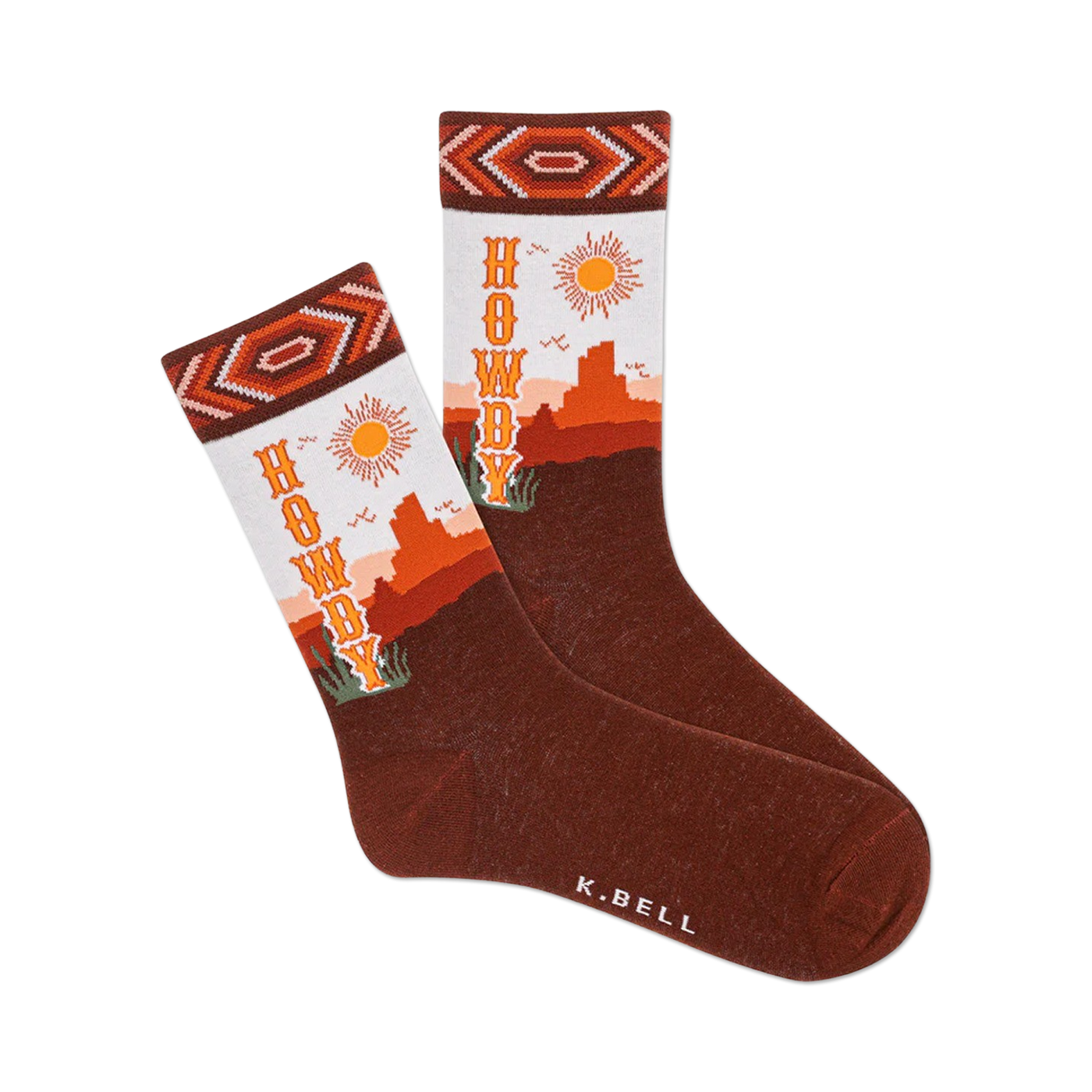 Pair of brown crew socks with an orange and white Southwestern design.  The socks say 'Howdy' and feature a desert landscape with a sun.
