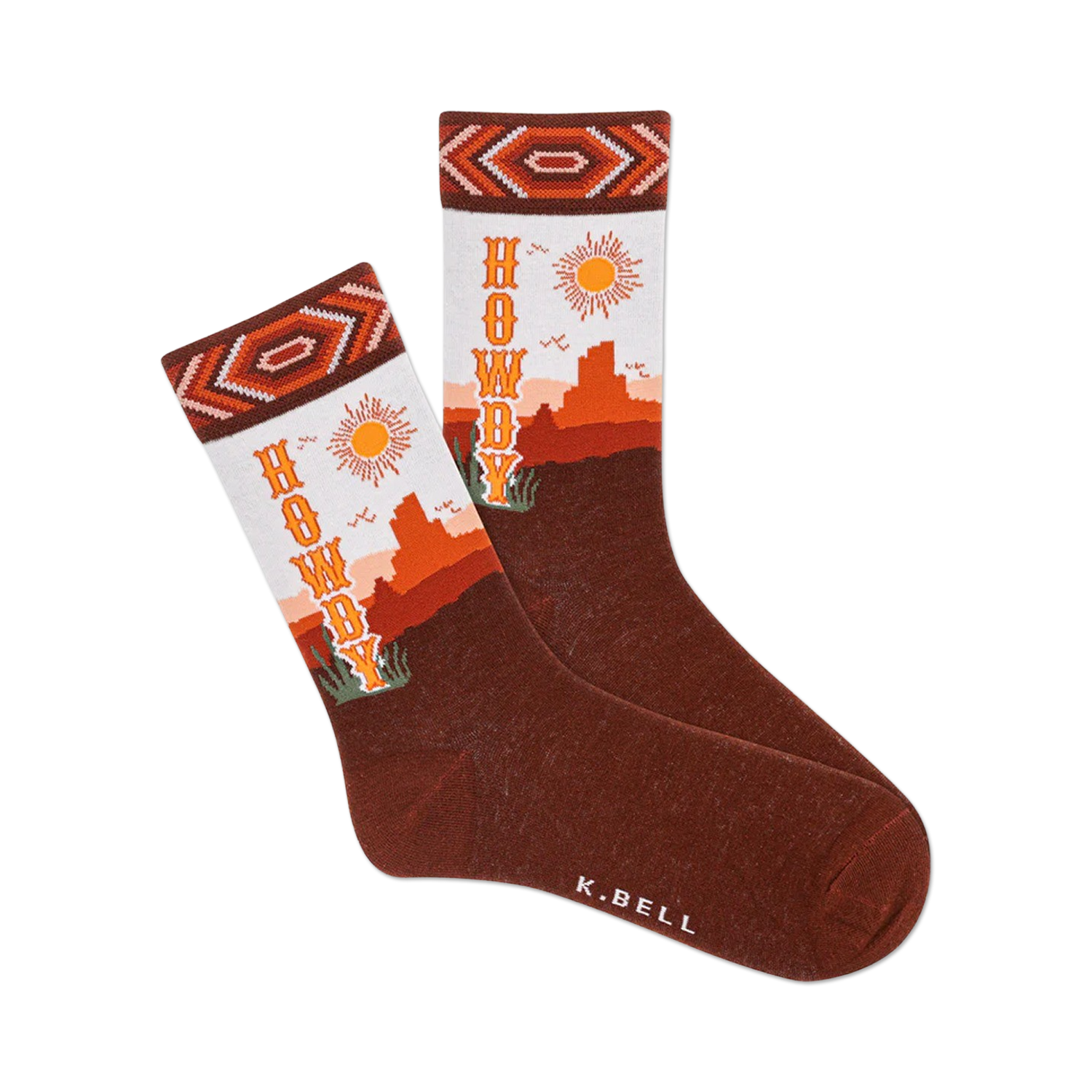Pair of brown crew socks with an orange and white Southwestern design.  The socks say 'Howdy' and feature a desert landscape with a sun.