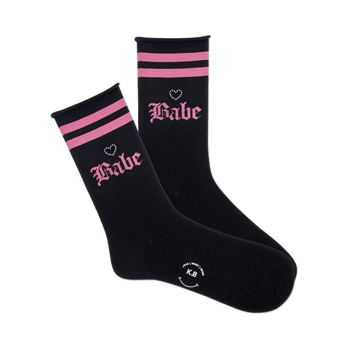 black crew length socks with pink stripes and the word 