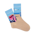 Pair of crew socks showcasing a beach scene with a pink lifeguard hut, ocean, and sand.  Socks are light beige with blue and pink design elements.