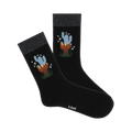 Pair of black crew socks with a sparkly silver cuff and a whimsical cactus design in blues and oranges.