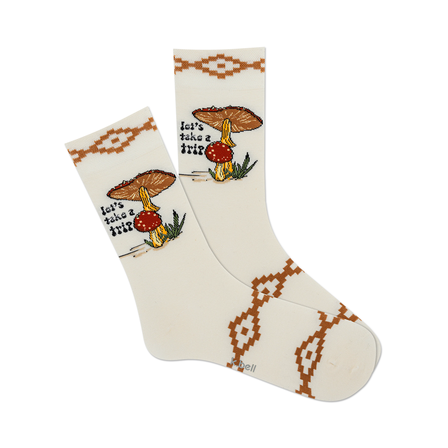 Pair of cream crew socks with brown mushroom illustration, 'Let's Take a Trip' text, and southwestern-style border.