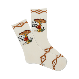 front view of a pair of white socks with a mushroom design and the words "let's take a trip".