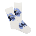 Pair of women's crew socks in white with a large blue floral design.  The flowers are a stylized blue and navy print.