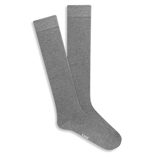Pair of knee-high light grey Modal socks with subtle ribbed comfort tops, displayed flat on a black background.