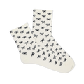 Pair of white microfiber anklet socks covered in a repeating pattern of small black bows, shown against a plain background.