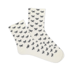 Pair of white microfiber anklet socks covered in a repeating pattern of small black bows, shown against a plain background.